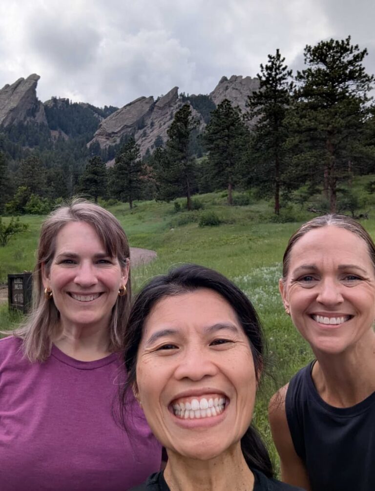 People take selfies against the backdrop of a forest