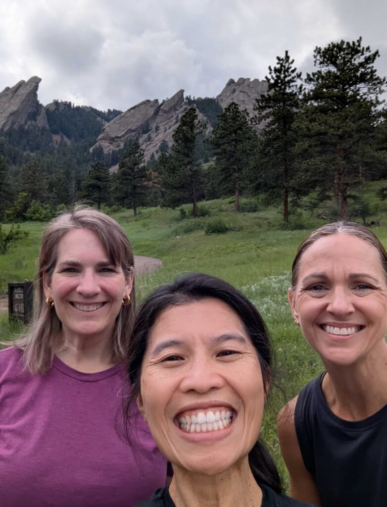 People take selfies against the backdrop of a forest